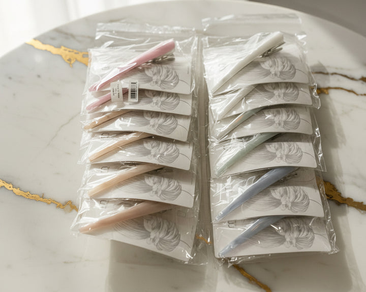 Set of hair extensions in clear packaging on a white surface