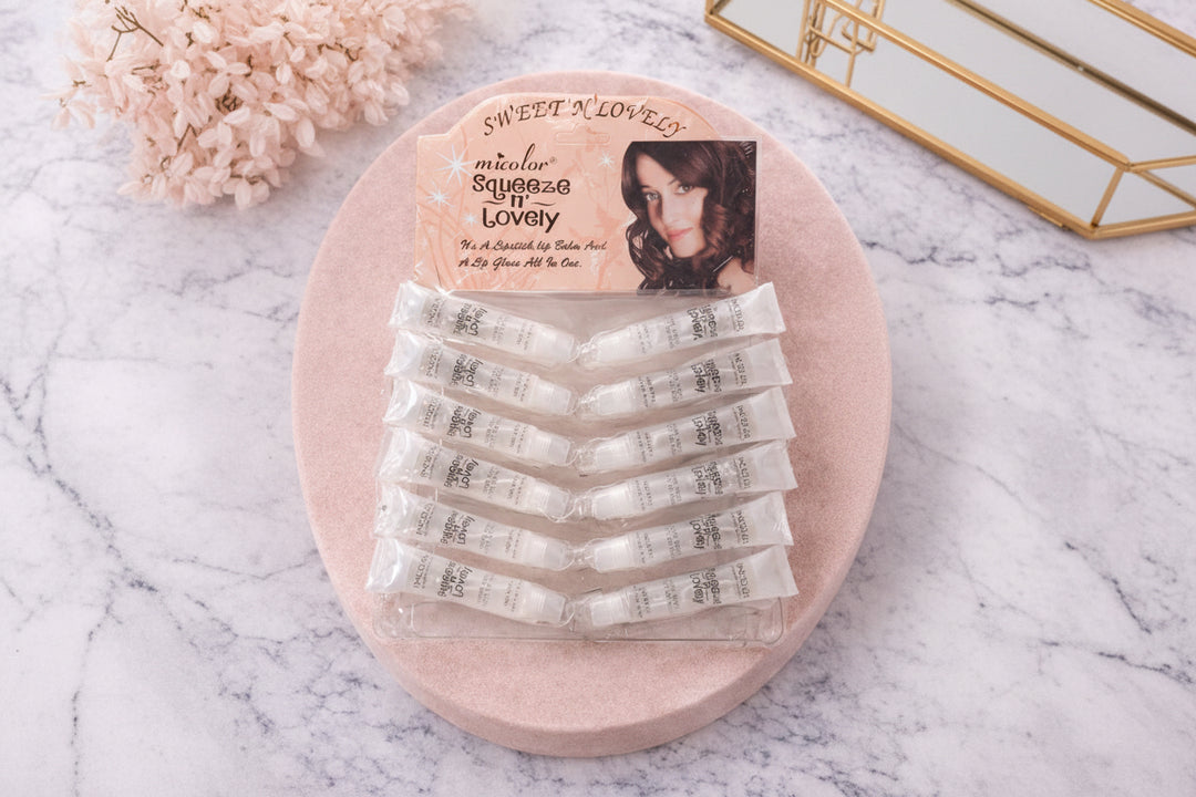 Set of lip balm lip glass 
 on a pink stand with 'Sweet N' Lovely' branding.